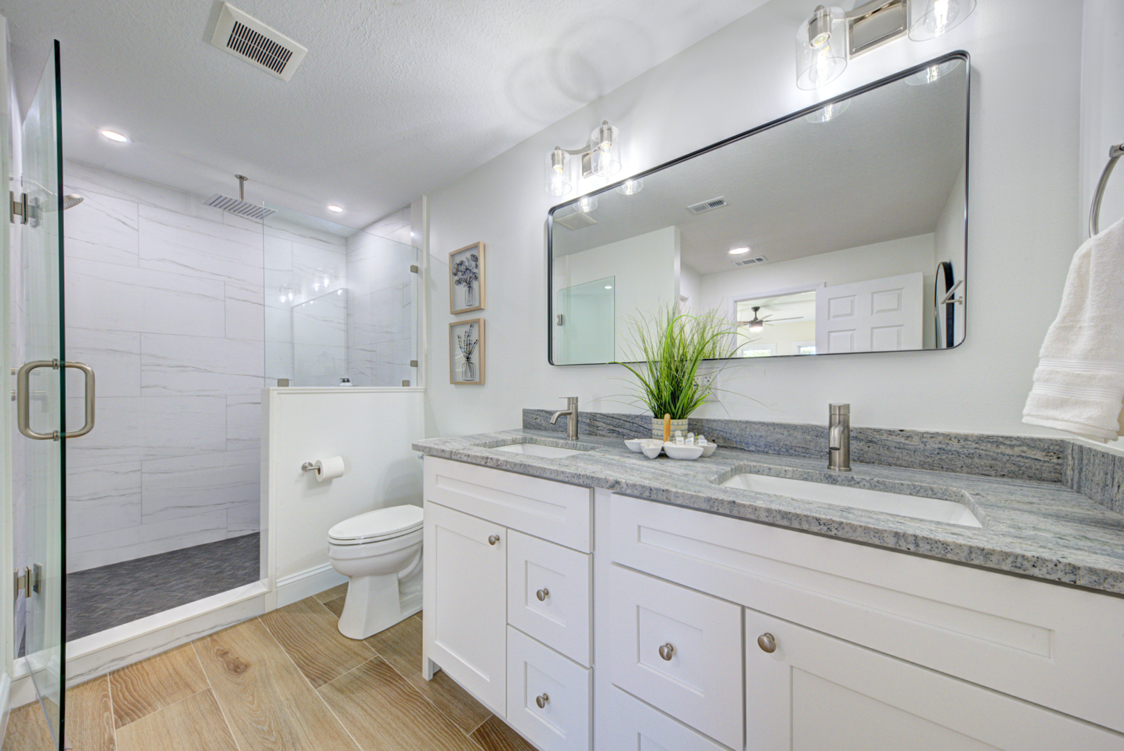 Spa-like bathroom with double vanity and marble shower