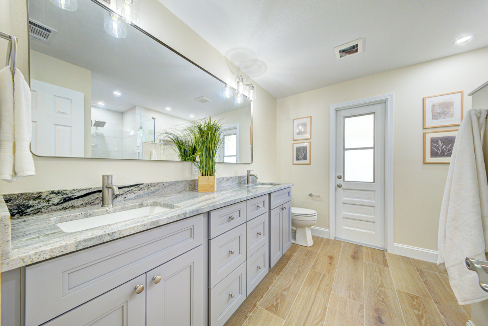Updated bathroom with gray vanity and granite top