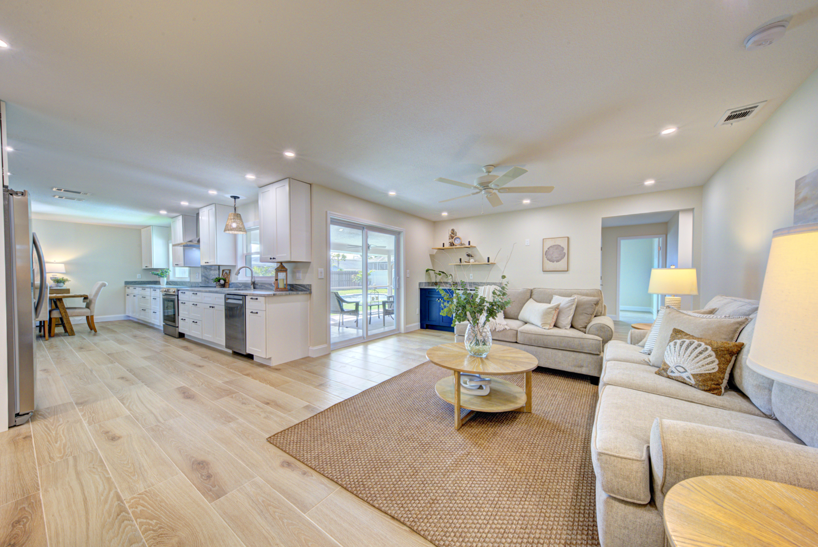 Coastal living room connected to updated kitchen